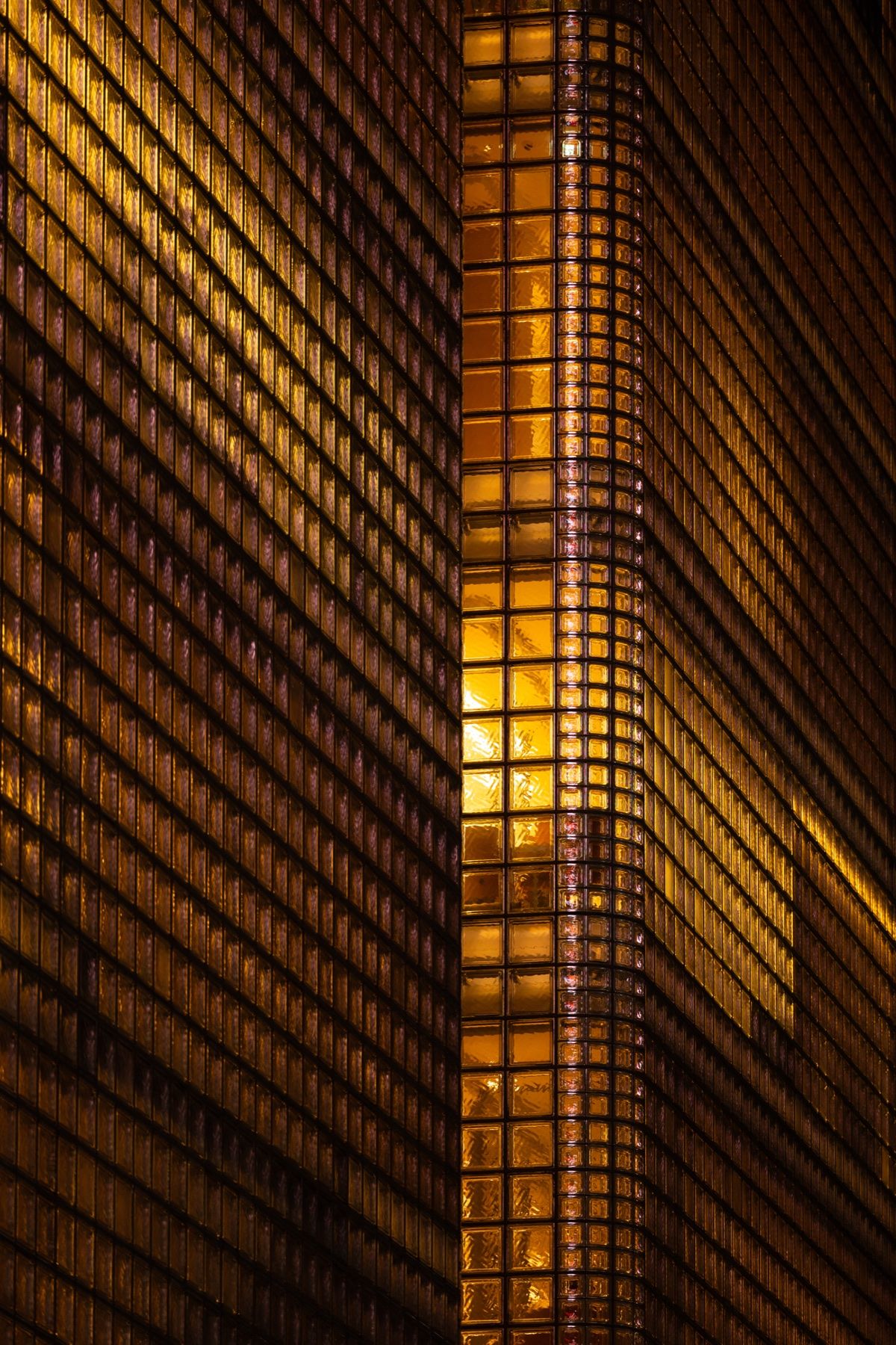 A golden lattice façade lit at night